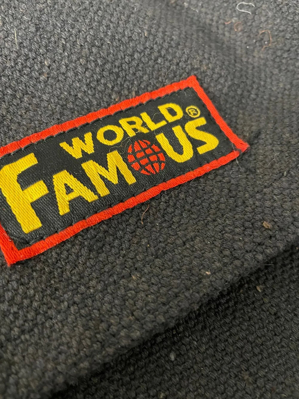 world famous faded messenger bag