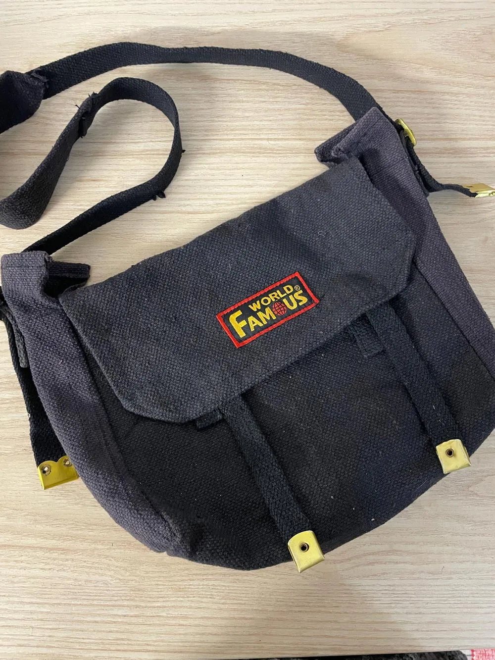 world famous faded messenger bag